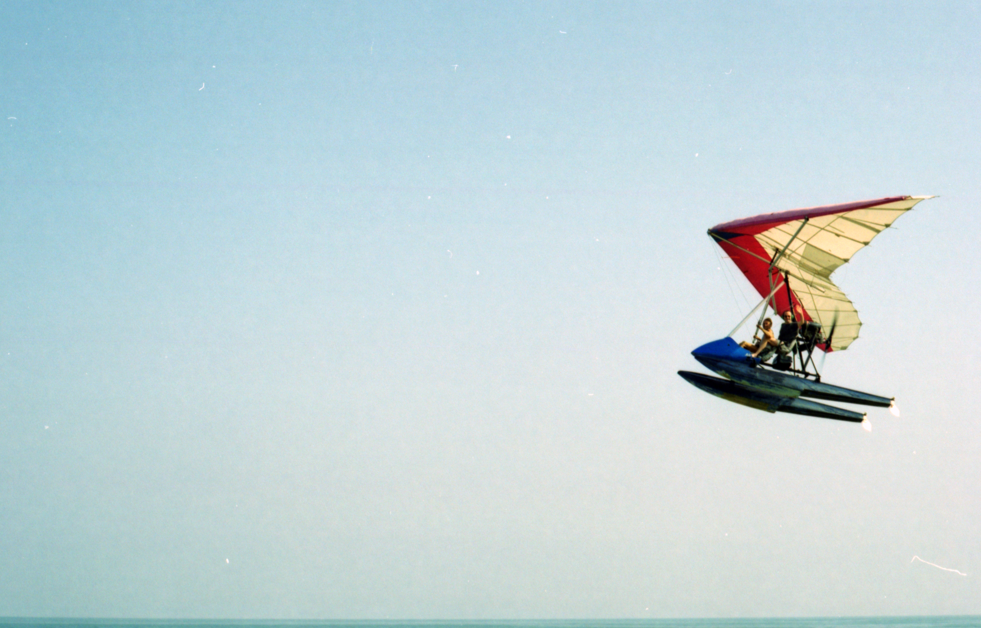 A microlight seaplane flying low over the sea